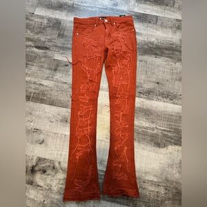 ORANGE DISTRESSED STACKED JEANS